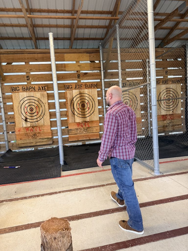 Sphinx team member throwing an axe at a team offsite
